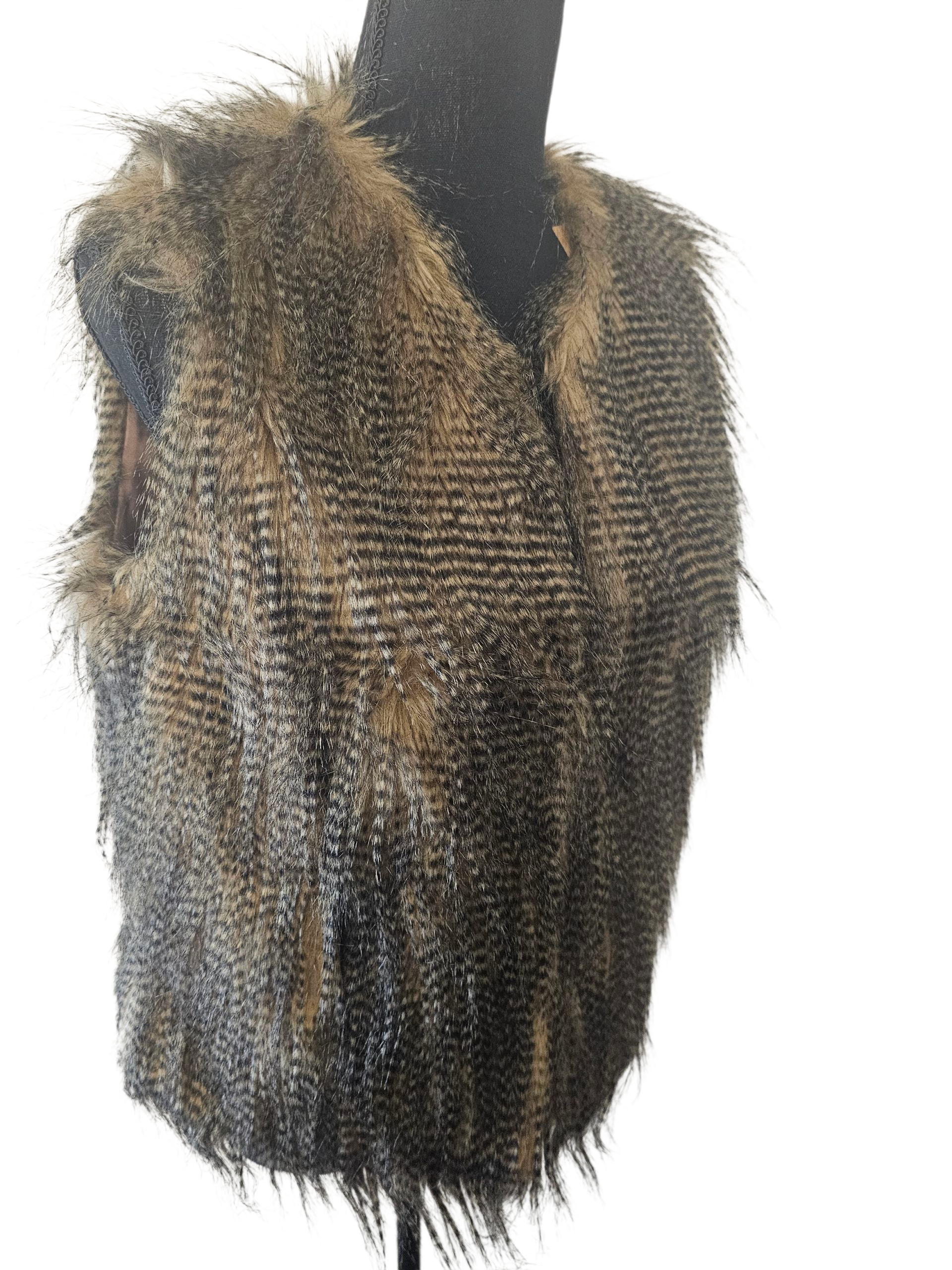 Feathered garment on a mannequin against a white background